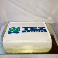 Белоснежный корпоративный торт с логотипом компании тэз тур заказать недорого в Минске.